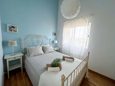 a blue bedroom with a bed with a plant on it at Un hogar lejos de tu hogar in Sal Rei