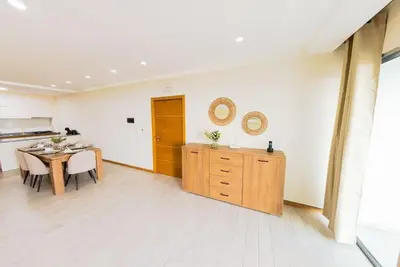a kitchen and dining room with a table and mirror at Jet Ap & Car 23 in Praia