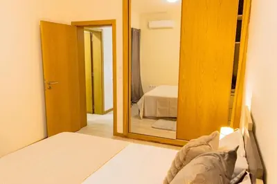 a bedroom with a mirror and a bed in a room at Jet Ap & Car 23 in Praia