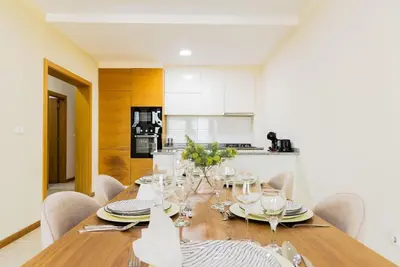 a dining room with a wooden table and chairs at Jet Ap & Car 23 in Praia