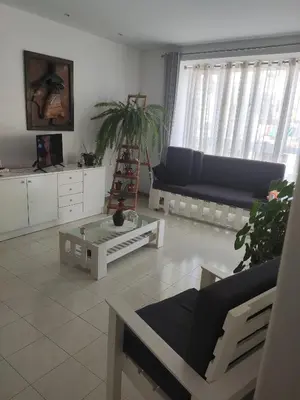 a living room with a couch and a coffee table at Casa fréd in Mindelo