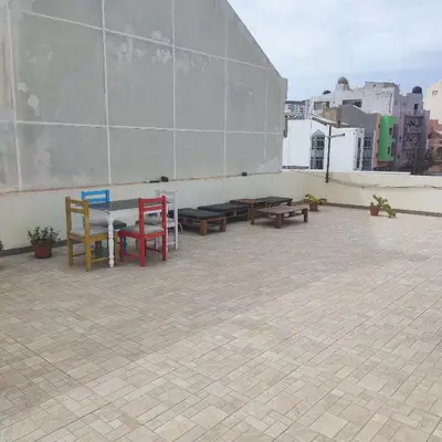 a patio with tables and chairs on top of a building at Casa fréd in Mindelo