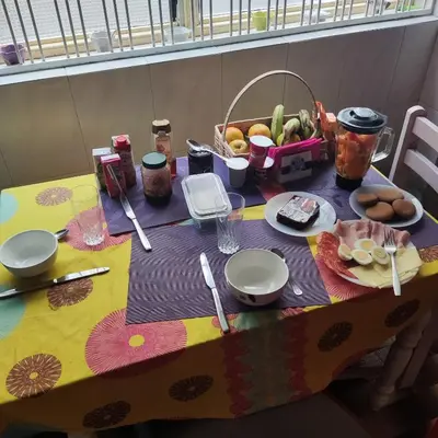 a table with a table cloth with food on it at Casa fréd in Mindelo