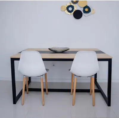 two white chairs sitting at a wooden table at Nikita in Praia