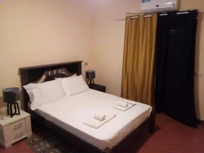 a bedroom with a bed with two towels on it at Padaria Portuguesa, with porch facing the street in Santa Maria