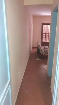 an empty hallway with a couch in a room at Padaria Portuguesa, with porch facing the street in Santa Maria