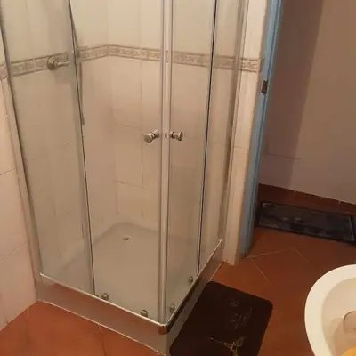 a shower stall in a bathroom with a toilet at Padaria Portuguesa, with porch facing the street in Santa Maria