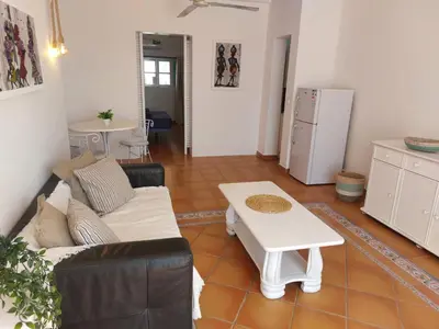 a living room with a couch and a table at Vista Mar - Seafront Holiday Apartments in Santa Maria