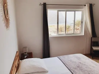 a bedroom with a bed and a window at Residencia Solimar in Ponta do Sol
