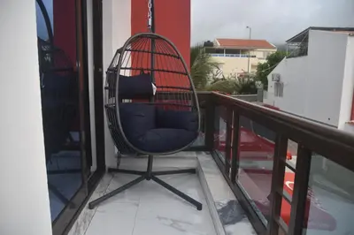 a rocking chair sitting on a balcony at Hotel Cantinho in Montanha