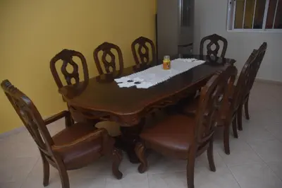a dining room table and chairs with debris on it at Hotel Cantinho in Montanha