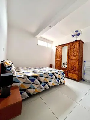 a bedroom with a bed and a wooden cabinet at Oásis de retour in Ponta do Sol