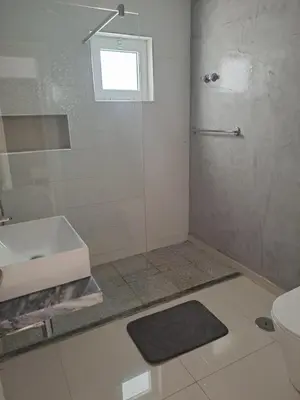 a bathroom with a shower and a sink and a toilet at Bela's house in Mindelo