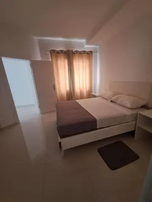 a bedroom with a large bed and a window at Bela's house in Mindelo