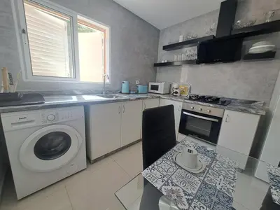 a kitchen with a washing machine and a sink at Bela's house in Mindelo