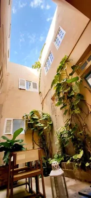 a building with a bench and plants on the side of it at Surfhouse Boavista in Sal Rei
