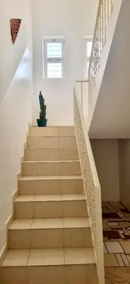 a staircase in a house with a cactus at Surfhouse Boavista in Sal Rei