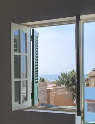 a window with a view of the ocean at Surfhouse Boavista in Sal Rei