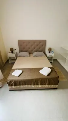 a bedroom with a bed with two towels on it at Hostel Rocha Marisol in Ponta do Sol