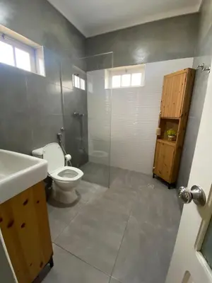 a bathroom with a toilet and a shower and a sink at Casa Aconchego - T2 in Espargos