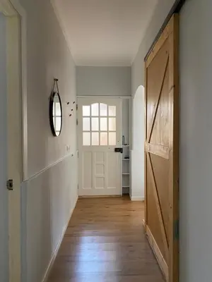 an empty hallway with a door and a mirror at Casa Aconchego - T2 in Espargos