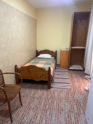 a bedroom with a bed and a chair in it at sweet single in Santa Maria