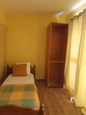 a bedroom with a bed and a book shelf at sweet single in Santa Maria