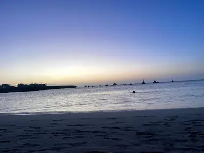a beach with a group of boats in the water at Chez Lena, Appartement confortable 3 chambres in Praia