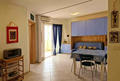 a kitchen with a table and chairs in a room at Tommy's Apartment in Santa Maria