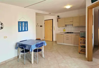 a kitchen with a table and chairs in a room at Tommy's Apartment in Santa Maria