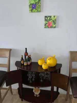 a table with bottles and fruit on top of it at Villa Vicente Casa Soares in Vila Nova Sintra
