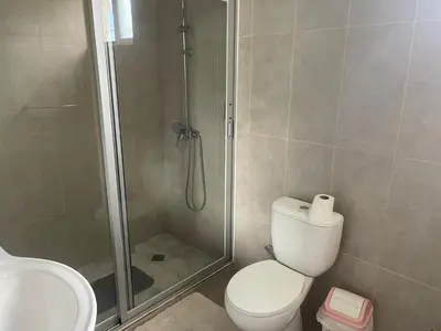 a bathroom with a shower and a toilet and a sink at Villa Vicente Casa Soares in Vila Nova Sintra
