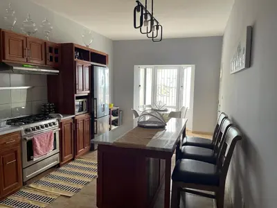 a kitchen with a kitchen island with a counter top at Villa Vicente Casa Soares in Vila Nova Sintra