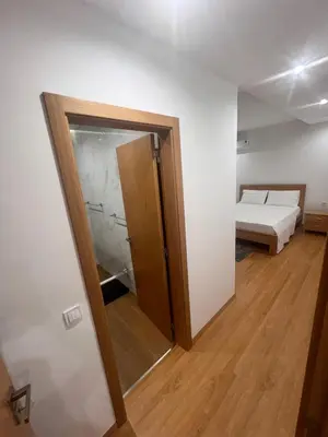 a room with a bed and a door to a bedroom at Ondas Relax House in Praia