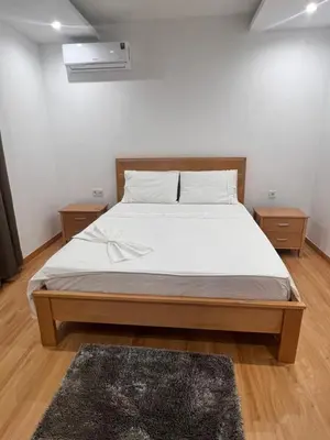 a bedroom with a large bed with white sheets at Ondas Relax House in Praia