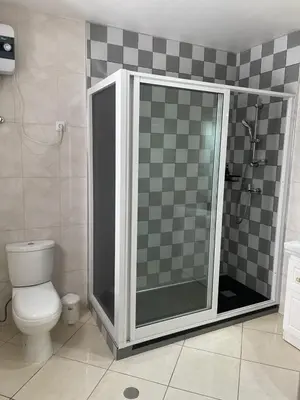a bathroom with a shower and a toilet in it at Casa Nela grand balcon vitré in Tarrafal