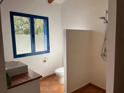 a bathroom with a toilet and a window at Casa Saúde in Seladinha