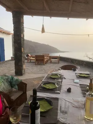 a table with glasses and wine bottles on a patio at Casa Saúde in Seladinha