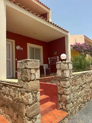 a stone wall in front of a house at Garoupa Stella Maris Apartamento N10 in Vila do Maio