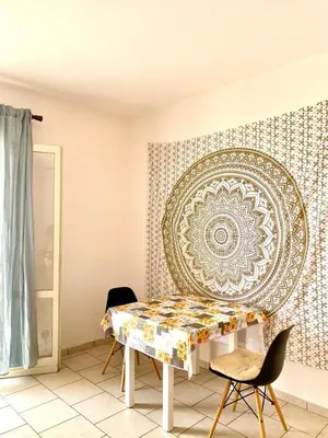 a dining room with a table and a decorative wall at Vista di mare in Sal Rei