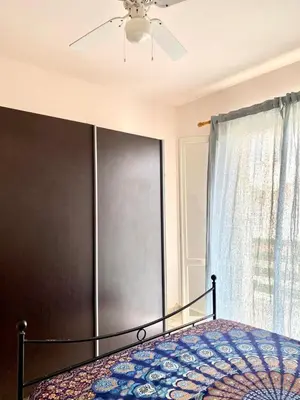 a bedroom with a bed with a ceiling fan and a window at Vista di mare in Sal Rei