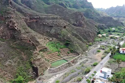 an aerial view of a mountain with a road and ruins at FADIAS Quartos - Rooms in Ribeira Grande