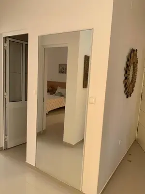 a large mirror in a room with a bedroom at Apartamento Moderno in Mindelo