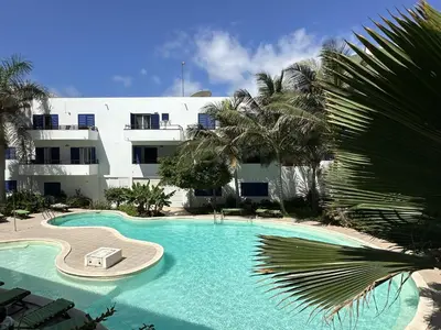 a large swimming pool in front of a building at FantaSea Apartment Leme Bedje in Santa Maria