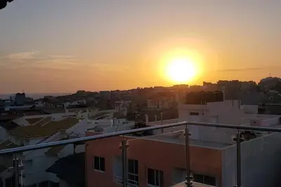 a view of the sunset from a building at Apto Duarte T1 Compacto in Praia