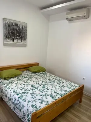 a bedroom with a bed with a floral bedspread at Apto Duarte T1 Compacto in Praia