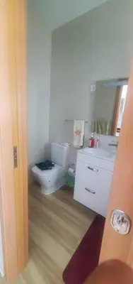 a bathroom with a toilet and a sink at Apto Duarte T1 Compacto in Praia