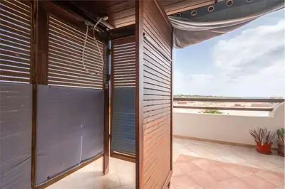 a room with a large window with blinds at Attico Residence Costa do Sol in Sal Rei