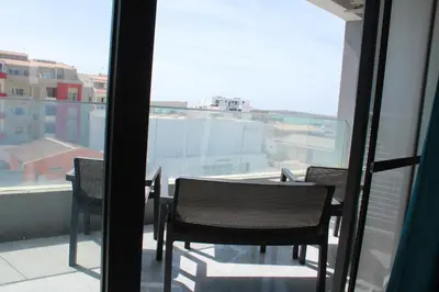 a balcony with two chairs and a table on a balcony at APARTAMENTO T2 - SAL REI - Boa Vista in Sal Rei