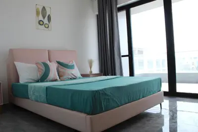 a bedroom with a bed with a large window at APARTAMENTO T2 - SAL REI - Boa Vista in Sal Rei
